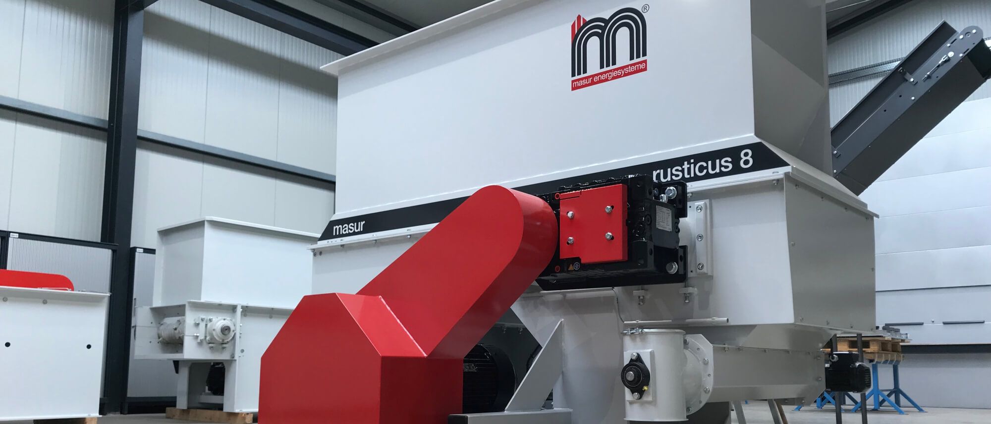 Masur Energiesystemes rusticus 8 machine system with red inlet pipe in an industrial hall
